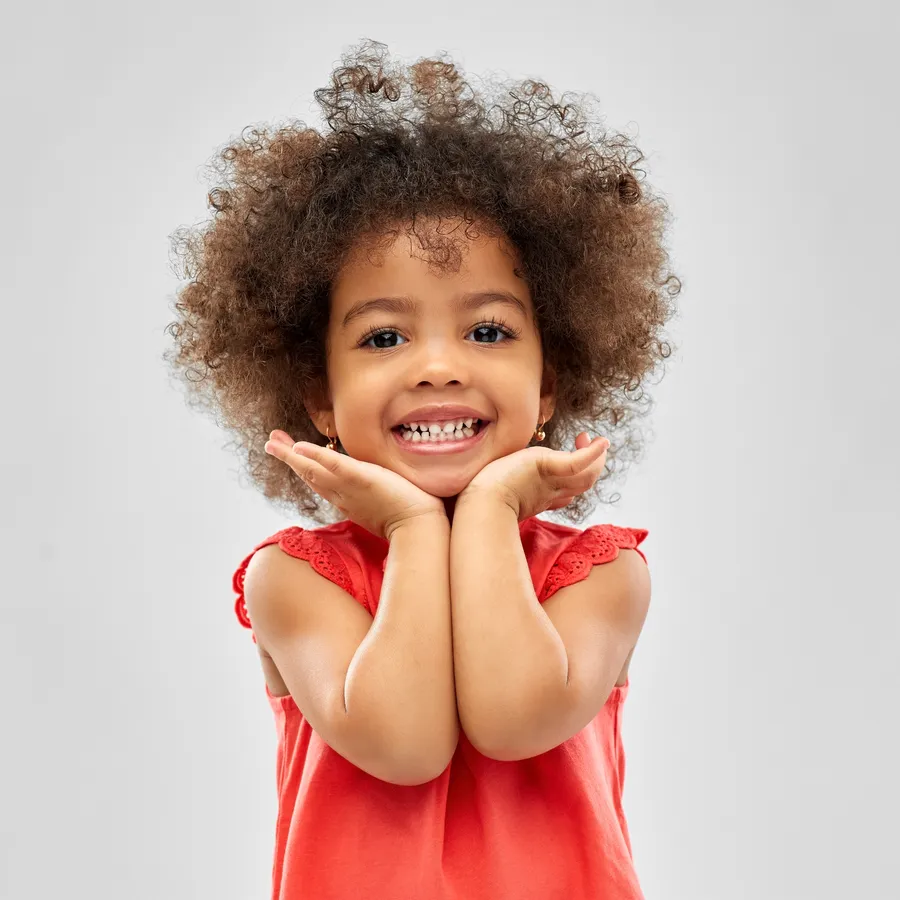Child smiling happily after a dental visit